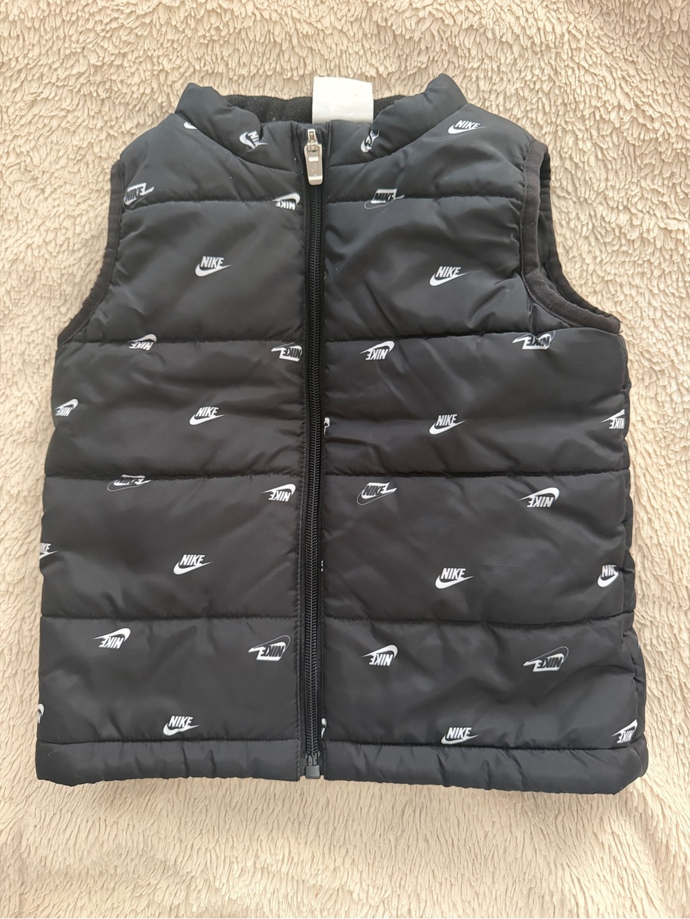 Kids black padded vest with Nike logos